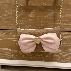 Betsy Johnson’s brown and beige pink pow cross body